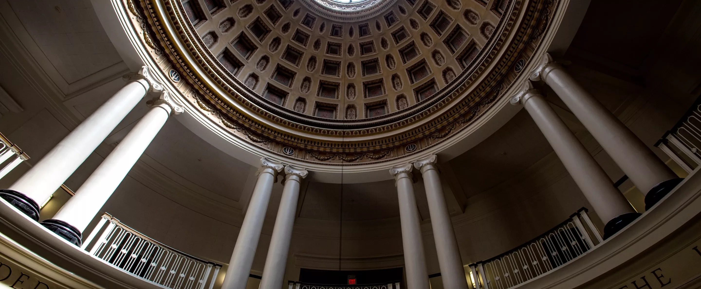 The compass rose window at the top of the dome in Grawemeyer Hall, with the rotunda in view
