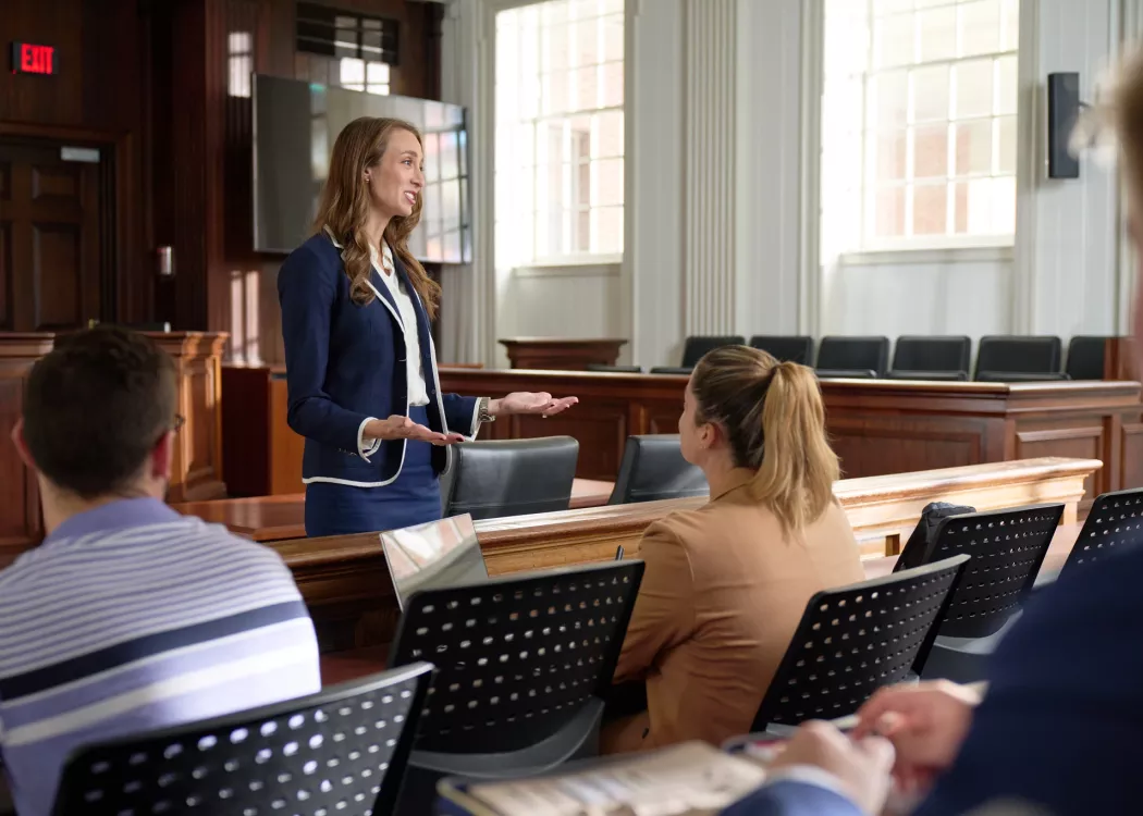 Sara Ochs teaching law in the classroom to multiple students.