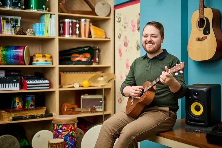 Portrait of Andrew Chapman in a music classroom environment