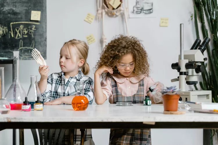 Two girls exploring science.
